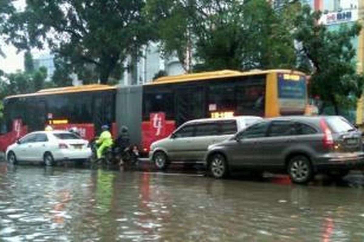 Genangan air di Jl Hayam Wuruk, Jakarta Pusat setinggi sekitar 40 cm, Rabu (29/1/2014) pagi sehingga hanya lajur kanan yang bisa dilewati. Foto diambil dari akun Twitter [at]antonpw.