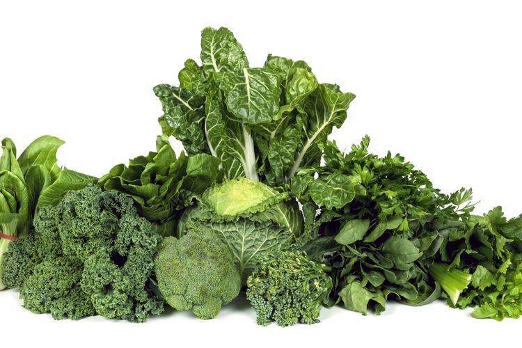 Variety of leafy green vegetables isolated on white background.