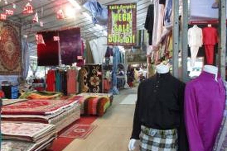 Terlihat busana Muslim dan karpet Persia yang didagangkan di Bazaar Ramadhan di Singapura.