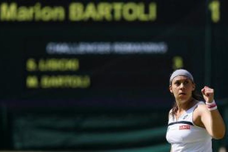 Petenis Perancis, Marion Bartoli, mengepalkan tangan, merayakan perolehan poin atas Sabine Lisicki dari Jerman, pada laga final turnamen Grand Slam Wimbledon, Sabtu (6/7/2103).