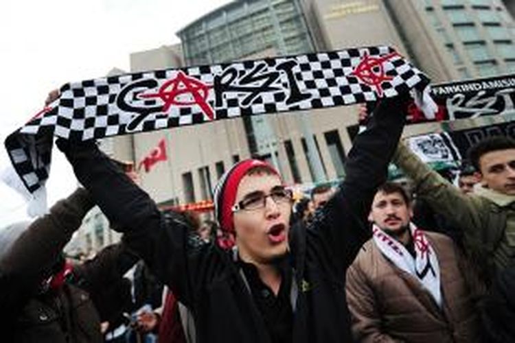 Para suporter klub sepak bola Besiktas melakukan unjuk rasa sambil membawa atribut klub di luar gedung pengadilan kriminal Istanbul, Turki untuk mendukung 35 suporter yang menjalani sidang karena didakwa hendak melakukan kudeta.