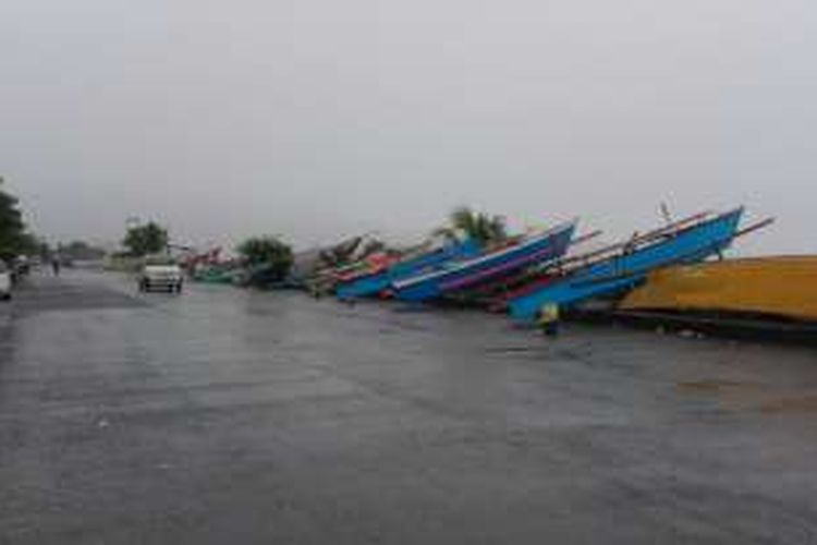 Perahu para nelayan terpaksa diparkir di tepi jalan karena cuaca buruk di Manado