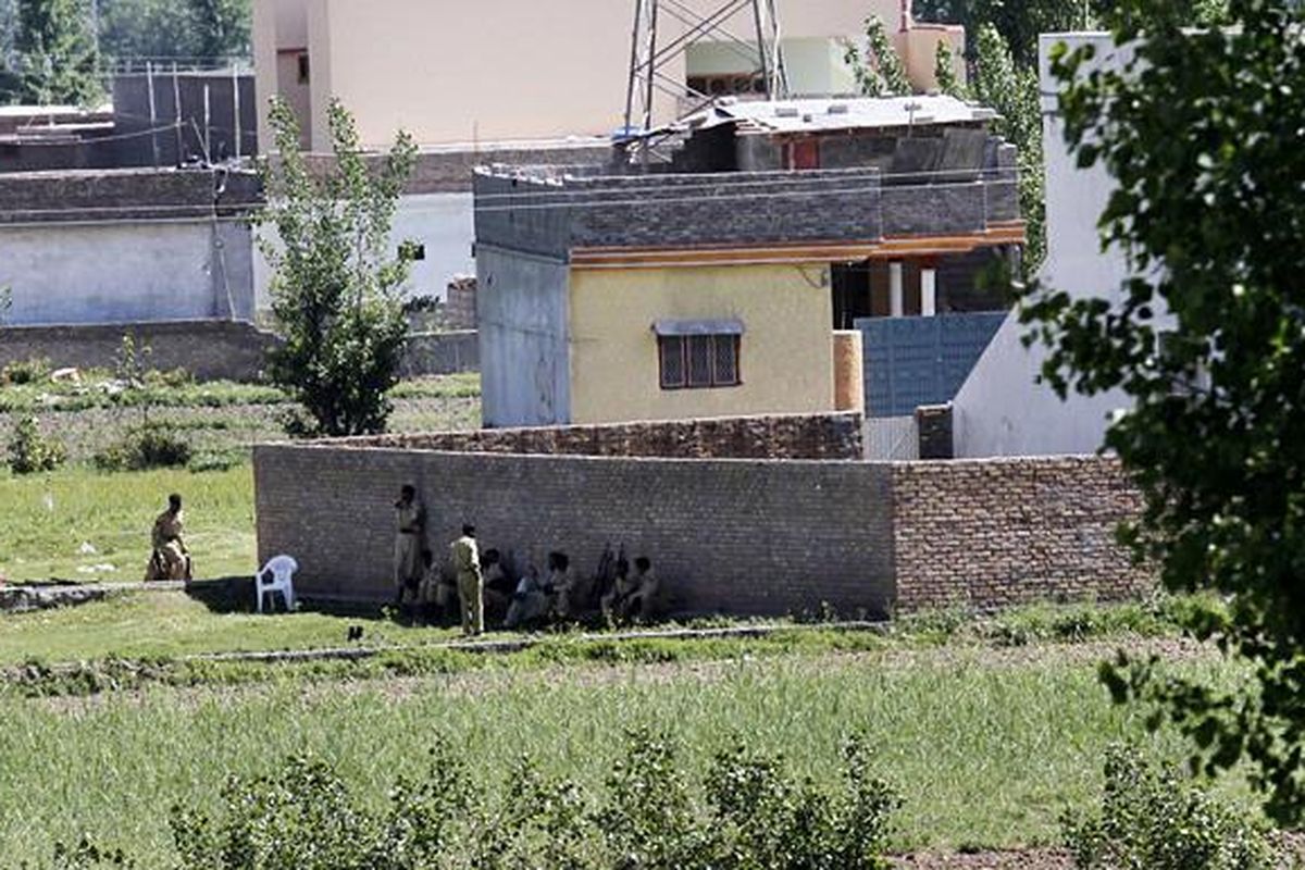 Tentara Pakistan beristirahat di dekat rumah yang diyakini tempat tinggal pemimpin Al Qaeda, Osama bin Laden, di kota Abbottabad, Pakistan, Senin (2/5). Rumah itu, Senin dini hari, diserbu pasukan khusus Amerika Serikat dalam sebuah operasi militer rahasia.