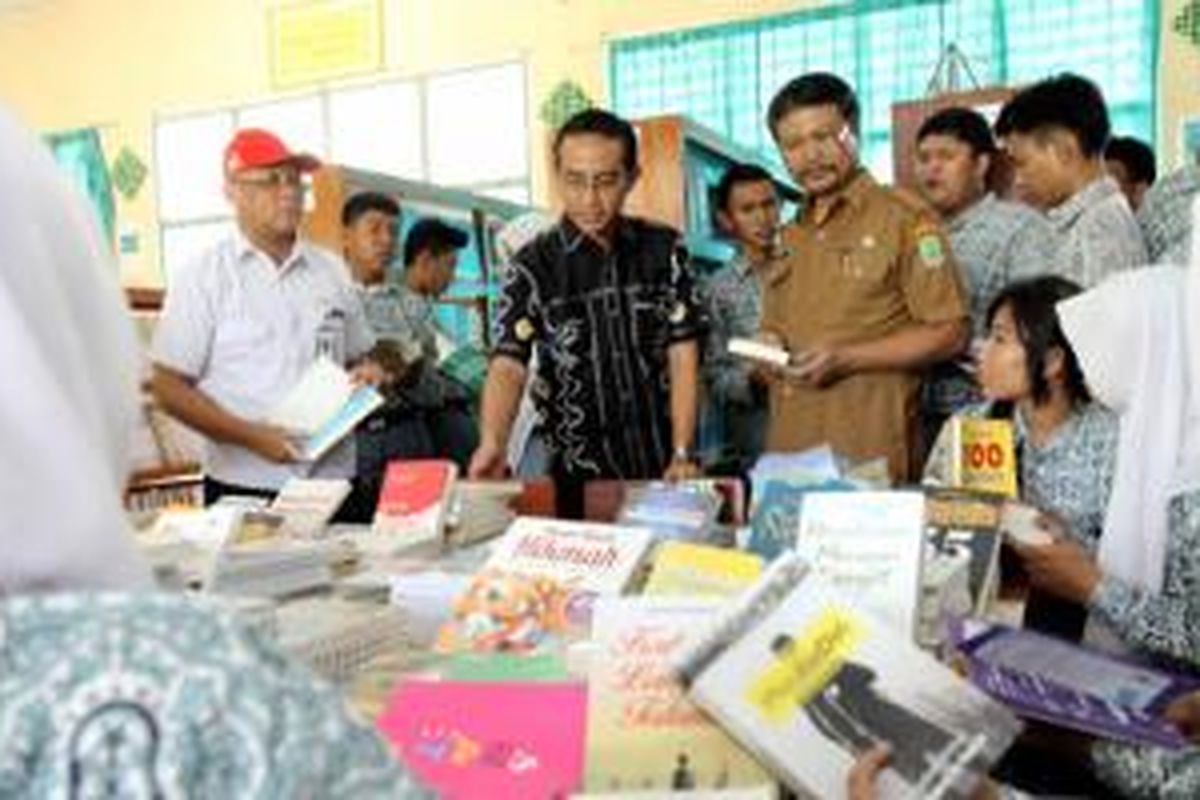 Ahmad Muhibbuddin (kiri) ikut membagikan buku bacaan dalam program bertajuk, “Sahabat Satu Hati Berbagi Buku dan Berbagi Ilmu”.