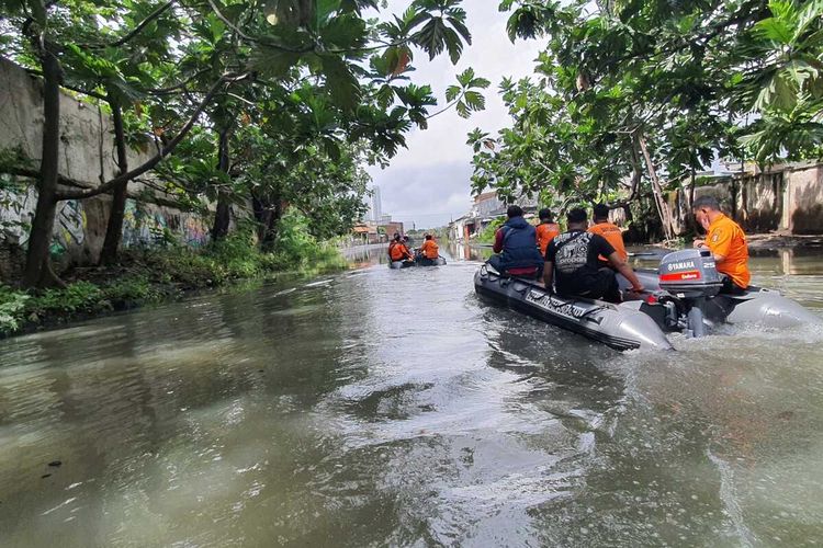 Petugas dari BPBD Surabaya, Jawa Timur, saat mengatasi banjir yang ada di beberapa kawasan di Surabaya, Senin (13/6/2022).
