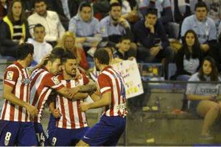 Striker Atletico Madrid, David Villa (2 dari kanan), mendapat sambutan dari rekan-rekannya usai mencetak gol ke gawang Celta Vigo dalam lanjutan La Liga, Sabtu (8/3/2014). Villa borong dua gol Atletico yang menang 2-0.