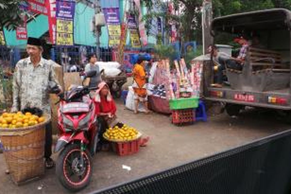 Pedagang kaki lima di Pasar Minggu menggunakan bahu jalan untuk menjual dagangannya, Senin (29/7/2013). Tampak pula mobil Satpol PP di sekitar lokasi para PKL.