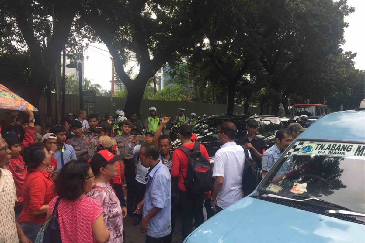 Para sopir angkot menutup Jalan Kebon Sirih di depan Gedung DPRD DKI Jakarta, Senin (22/1/2018). Para sopir berharap anggota DPRD DKI membantu mereka untuk berbicara dengan Pemprov DKI agar Jalan Jatibaru Raya, Tanah Abang, bisa kembali dilintasi.