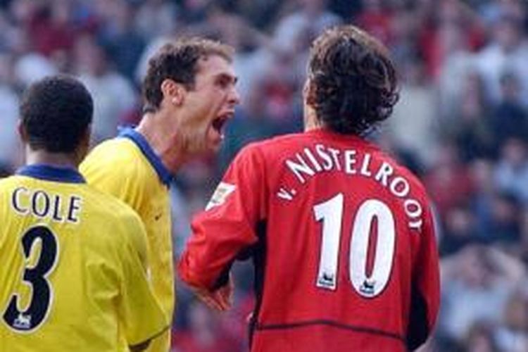 Bek Arsenal, Martin Keown (tengah), terlibat konfrontasi dengan penyerang Manchester United, Ruud van Nistelrooy (kanan), pada laga di Old Trafford, Manchester, 21 September 2003.
