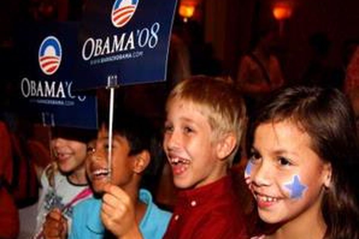 Para bocah girang sambil mengangkat poster di acara pesta perayaan inaugurasi Barack Obama di Hotel JW Marriot, Jakarta, Selasa (20/1) malam.