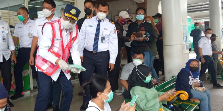 A file photo of Transportation Minister Budi Karya Sumadi distributes masks to train passengers in Yogyakarta. 