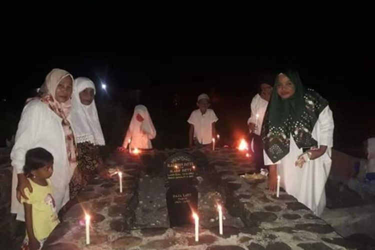 Warga di Desa Latu, Kecamatan Amalatu, Kabupaten Maluku Tengah menerangi kuburan keluarganya dengan membakar damar pada malam 27 likur atau malam 27 Ramdhan 1441 hijriah, Selasa (19/5/2020)
