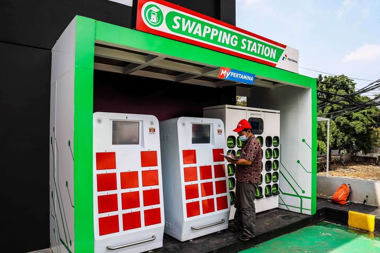An employee is checking on a swapping station for electric vehicles in Jakarta at one of the gas stations provided by state-owned firm Pertamina on Monday, March 28, 2022.  