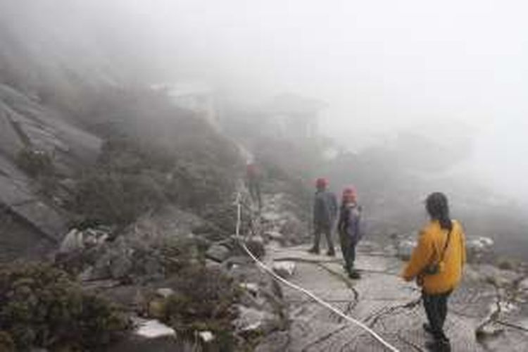 Pendaki menuju Sayat-Sayat Check Point setelah mencapai puncak Gunung Kinabalu, Sabah, Malaysia, Selasa (22/11/2016). Kini, pasca gempa Gunung Kinabalu pada Juli 2015, pendaki tak perlu berjalan di pinggir tebing gunung untuk menuju Sayat-Sayat Check Point.