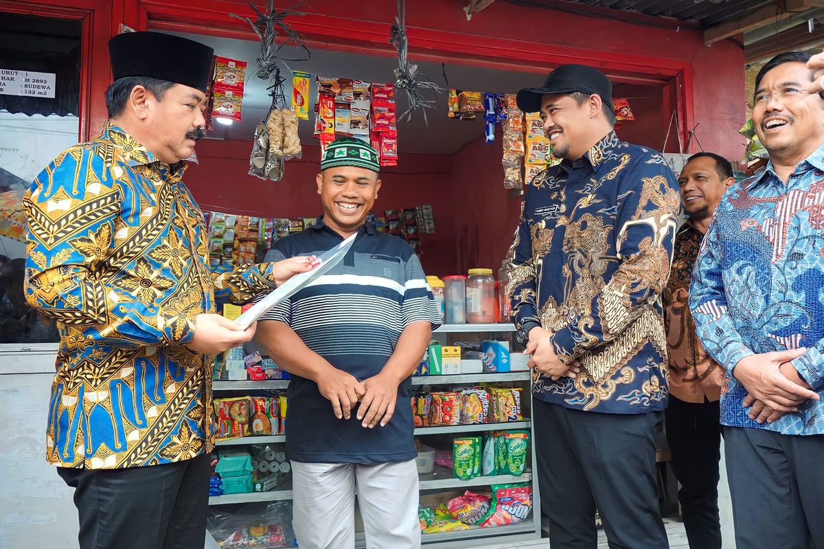  Menteri Agraria dan Tata Ruang/Kepala Badan Pertanahan Nasional (Menteri ATR/BPN) Hadi Tjahjanto bersama  Wali Kota Medan Bobby Nasution membagikan Sertifikat PTSL kepada 10 warga Kecamatan Medan Denai di Jalan Jermal VII, Kecamatan Medan Denai, Kamis (20/7/2023) .
