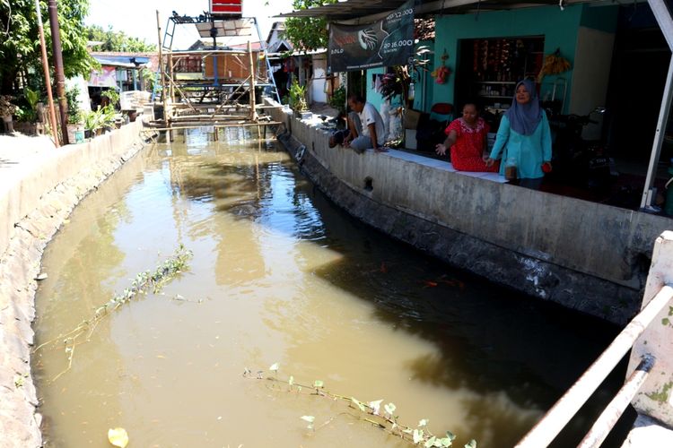Warga yang tinggal di bantaran Sungai Sinoman, Kota Mojokerto Jawa Timur, menebarkan pakan ikan ke sungai, Jumat (13/11/2020). Sejak 6 bulan lalu, sungai tersebut dimanfaatkan untuk memelihara ikan sekaligus untuk menjaga agar sungai tidak menjadi tempat pembuangan sampah..