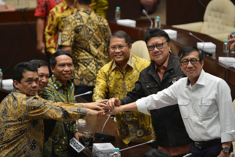 Menkumham Yasonna Laoly (kanan), Mendagri Tjahjo Kumolo (kedua kanan), Menkominfo Rudiantara (ketiga kanan), Ketua Komisi II DPR Zainudin Amali (ketiga kiri), Wakil Ketua Komisi II DPR Fandi Utomo (kedua kiri) dan Ahmad Riza Patria saling bertumpu tangan seusai rapat kerja di Kompleks Parlemen, Senayan, Jakarta, Jumat (20/10/2017). Pemerintah dan Komisi II DPR menyepakati pengunduran pengesahan RUU Ormas tingkat satu pada Senin (23/10/2017).