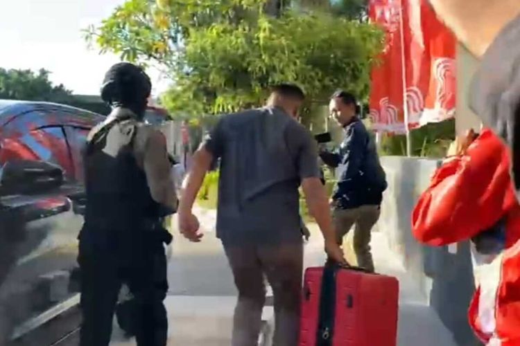 Tim KPK membawa keluar sebuah tas merah usai 7 jam menggeledah gedung sekretariat Pemprov Jatim, Jumat (16/82024).