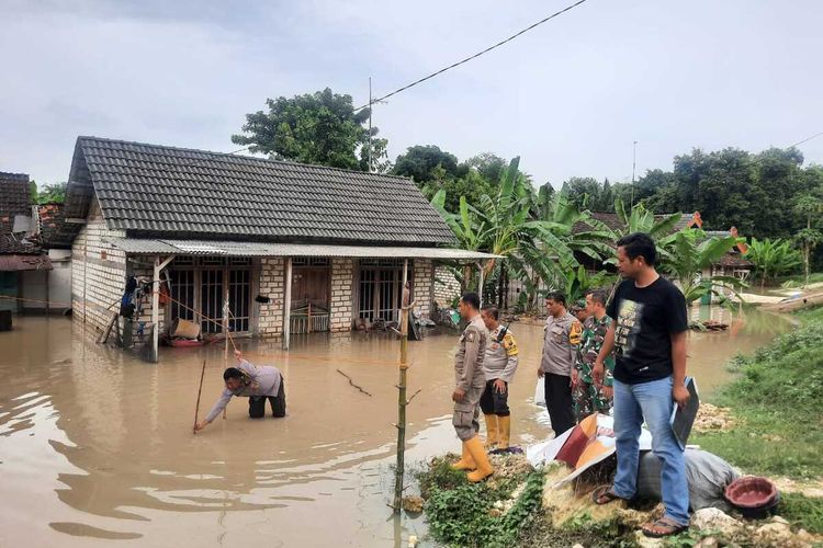 Petugas Kepolisian melakukan olah tempat kejadian tenggelamnya seorang bocah berinisian WAP (5), di Desa Gendongarum, Kecamatan Kanor, Kabupaten Bojonegoro, Jawa Timur, saat terjadi banjir sungai bengawan solo meluap, Senin (11/3/2024).