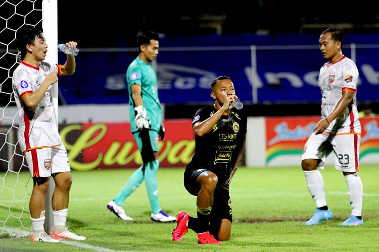 Pemain Arema FC Dendi Santoso minum disela-sela pertandingan pekan 32 Liga 1 2021-2022 melawan Borneo FC yang berakhir dengan skor 2-2 di Stadion I Gusti Ngurah Rai Denpsar, Minggu (20/3/2022) malam.