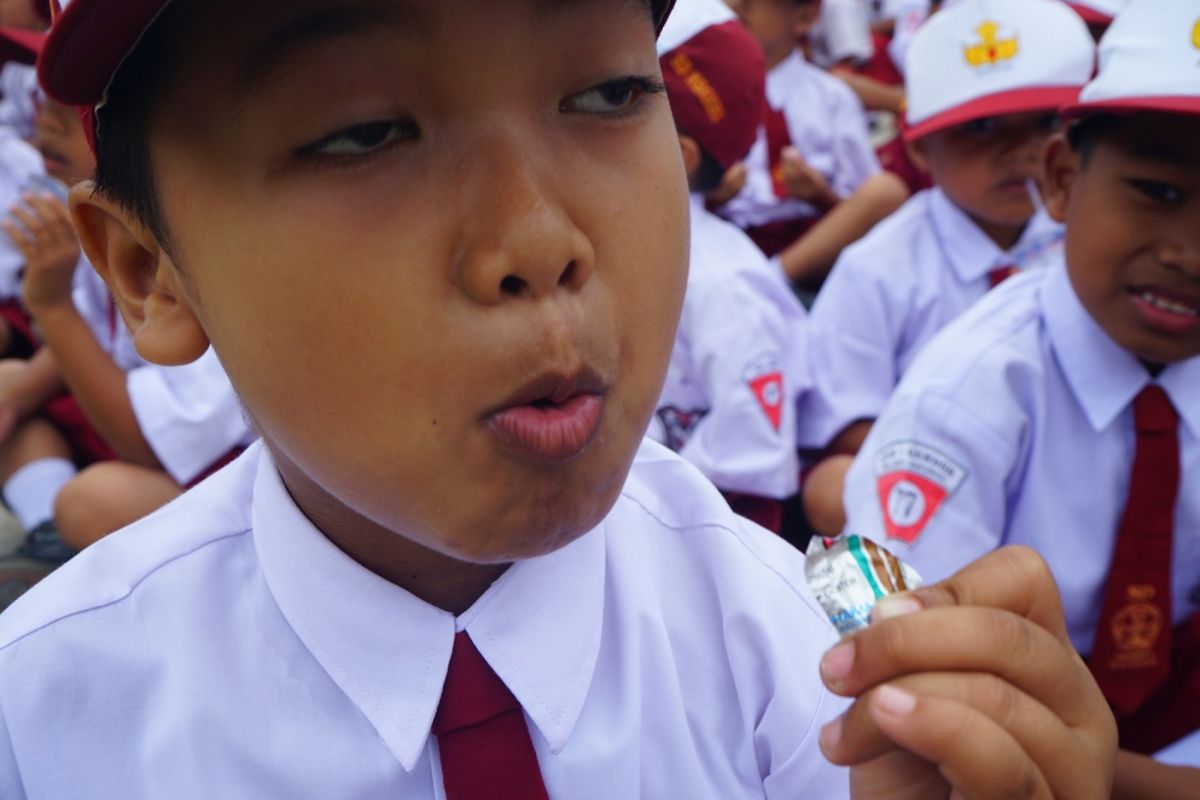 Salah satu siswa saat minum obat cacing bersama-sama.