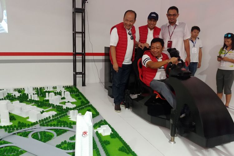 Dirut Telkomsel, Ririek Adriansyah (duduk memegang stir) menjajal teknologi remote driving yang mengandalkan koneksi 5G yang minim latensi.