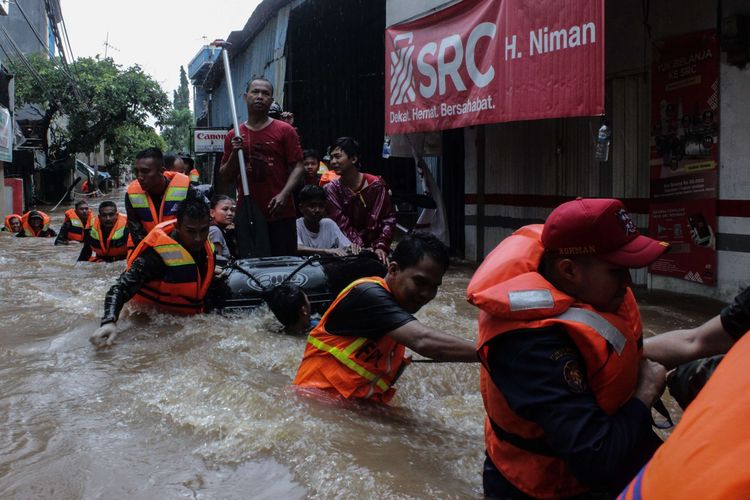 Para petugas mengevakuasi warga yang masih terjebak dipemukiman RW 04, Cipinang Melayu, Makasar, Jakarta Timur, Selasa (25/2/2020) yang dilanda  banjir. Banjir di wilayah sudah terjadi sejak Minggu (23/2/2020).