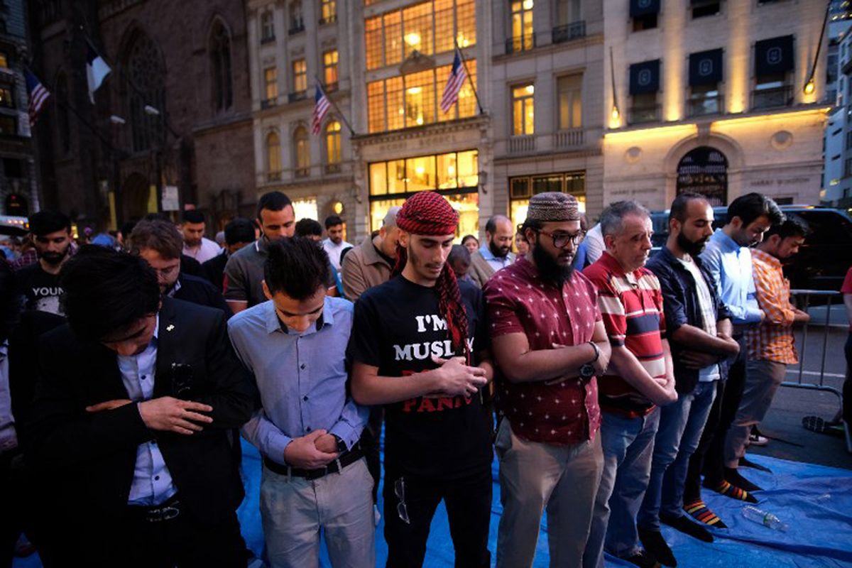 Umat Muslim di New York, Amerika Serikat menggelar shalat berjamaah di jalan dekat Trump Tower di the Fifth Avenue, New York, usai berbuka puasa bersama, Kamis (1/6/2017) waktu setempat.  