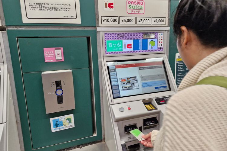 Seorang wisatawan sedang mengisi IC Card di salah satu stasiun di Tokyo, Jepang, Senin (6/11/2023).