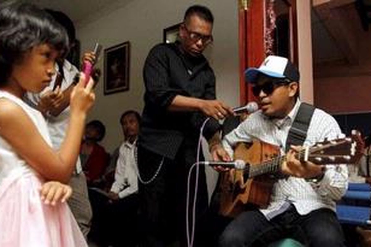 Penyanyi Glenn Fredly menyumbangkan lagu kepada jemaat Gereja Kristen Indonesia (GKI) Yasmin dalam ibadah Natal di salah satu rumah warga jemaat di komplek perumahan Taman Yasmin, Bogor, Jawa Barat, Minggu (25/12/2011). Untuk kedua kalinya jemaat GKI Yasmin dilarang menjalankan ibadah perayaan Natal di gedung gereja. 