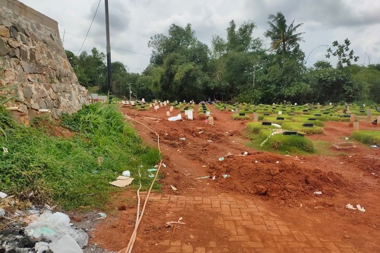Sampah Alat Pelindung Diri (APD) berserakan di area makam jenazah Covid-19 TPU Jombang, Ciputat, Tangerang Selatan, Senin (18/1/2021)