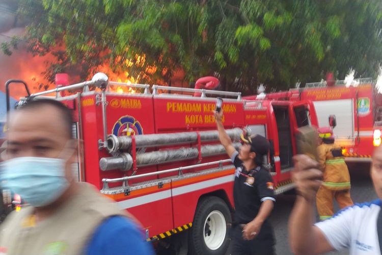 Pemadam Berusaha Memadamkan api yang melalap toko bangunan, Selasa (7/9/2021).