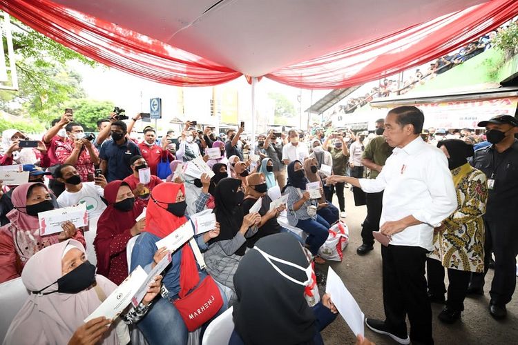 Presiden Joko Widodo (Jokowi) saat melakukan interaksi langsung bersama dengan penerima manfaat bantuan dan pedagang di Pasar Cibinong saat memberikan bantuan sosial (Bansos), Selasa (17/5/2022).
