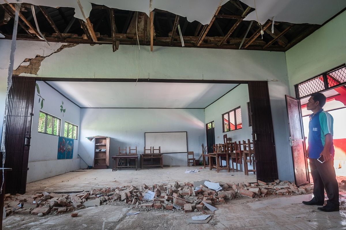 Petugas sekolah melihat kondisi ruang kelas yang rusak akibat gempa di SDN Kerta Mukti, Sumur, Pandeglang, Banten, Sabtu (15/1/2022). BPBD Provinsi Banten mencatat sebanyak 25 bangunan sekolah rusak akibat gempa berkekuatan 6,7 SR yang terjadi pada Jumat (14/1) sehingga sebagian kegiatan belajar mengajar (KBM) terpaksa diliburkan. ANTARA FOTO/Muhammad Bagus Khoirunas/nym.