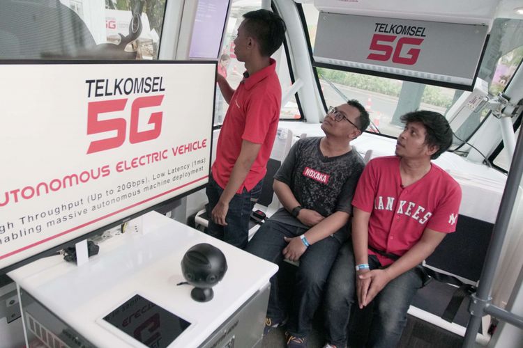 Sejumlah pengunjung saat mencoba kendaraan otonomos Navya di booth Telkomsel saat acara Asian Games di GBK Senayan, Jakarta, Kamis (23/08/2018). Mobil ini merupakan mobil tanpa awak pengemudi yang dihadirkan operator seluler Telkomsel selama acara Asian Games berlangsung.