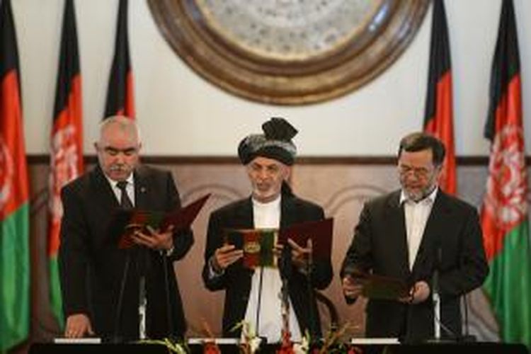 Presiden baru Afganistan Ashraf Ghani menuntut pembacaan sumpat kedua wakil presidennya mantan panglima perang Abdul Rahid Dostum (kiri) dan mantan Menteri Kehakiman Sarwar Danish (kanan) di istana kepresidenan Kabul, Senin (29/9/2014).


