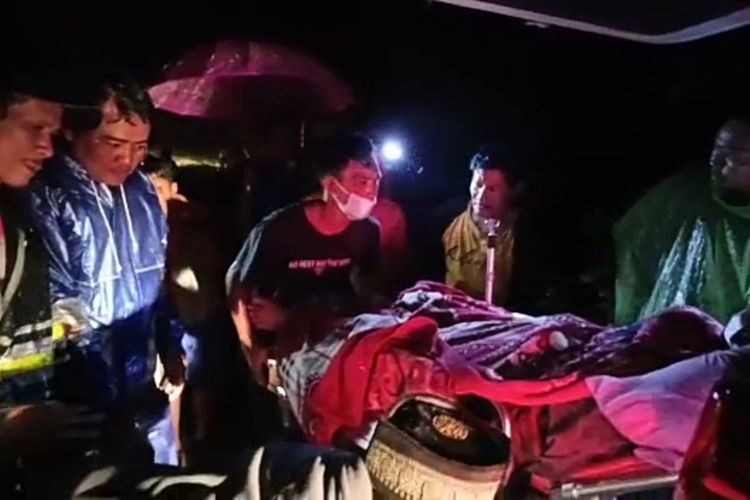 Warga jalan lintas Kecamatan Kelumbayan bergotong royong memindahkan pasien ke ambulans lantaran terjebak longsor pada Kamis (7/10/2022).