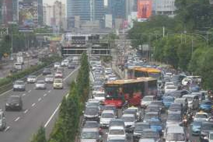 Antrian kendaraan roda empat yang hendak keluar dari Tol Dalam Kota dari pintu tol Semanggi, Selasa (21/6/2016). Terlihat kondisi ini membuat perjalanan bus transjakarta menjadi tersendat.