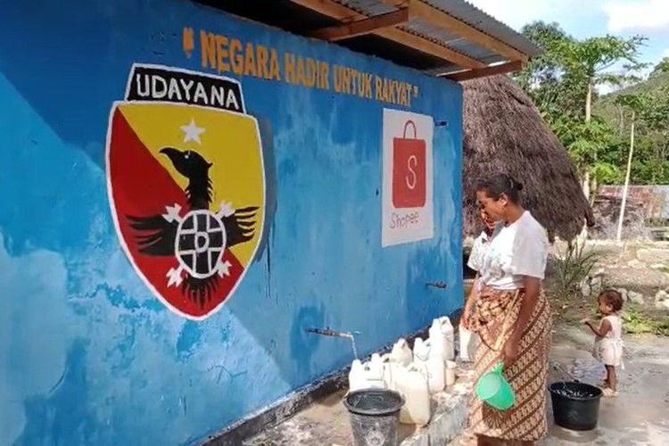 Warga Desa Pana mengambil air dari tangki air bersih di dekat rumah mereka