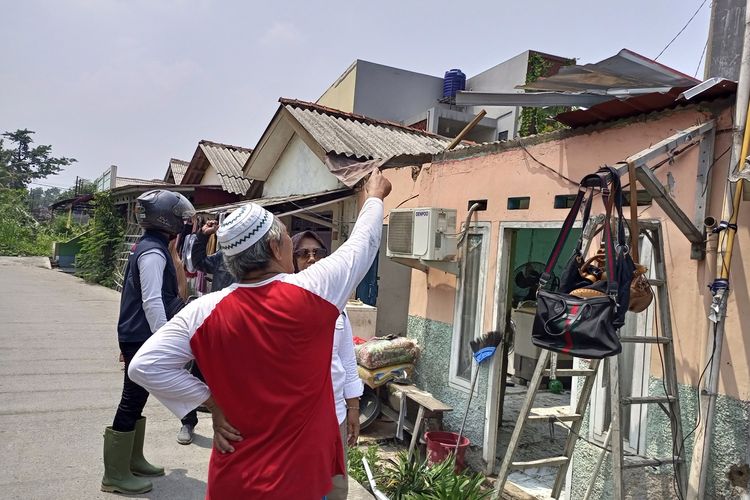 Sejumlah warga sedang bergotong royong membenahi rumah yang rusak akibat diterjang angin kencang di Ciomas, Kabupaten Bogor, Jawa Barat, Rabu (1/11/2023).