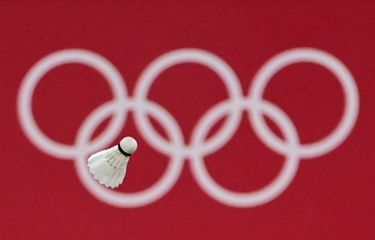 A shuttlecock flies in front of the Olympic rings logo during the women's singles badminton round of 16 match between Japan's Akane Yamaguchi and South Korea's Kim Ga-eun during the Tokyo 2020 Olympic Games at the Musashino Forest Sports Plaza in Tokyo on July 29, 2021. (Photo by Pedro PARDO / AFP)