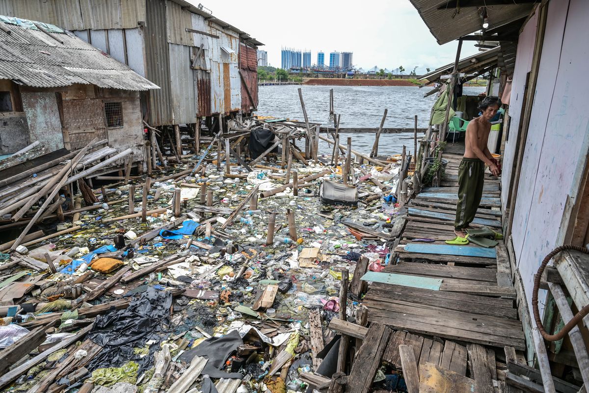 Seorang warga berjalan di titian rumahnya di Kampung Pojok, Kecamatan Penjaringan, Jakarta, Senin (5/2/2024). Pemerintah menargetkan angka kemiskinan ekstrem di Indonesia menjadi 0 persen pada 2024, setelah mengalami penurunan 1,12 persen pada 2023. 