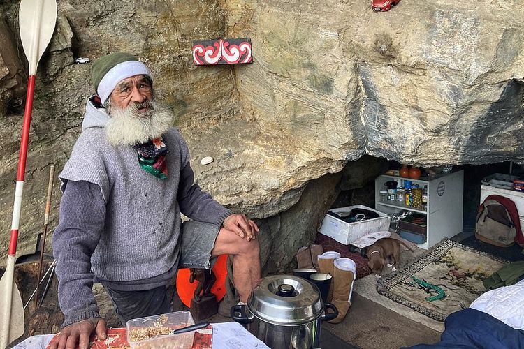 Pria Maori, 64, mendirikan kemah di sebuah gua batu tua di seberang jalan yang dipenuhi rumah-rumah bernilai jutaan dolar di tepi pantai yang terkenal di dunia
