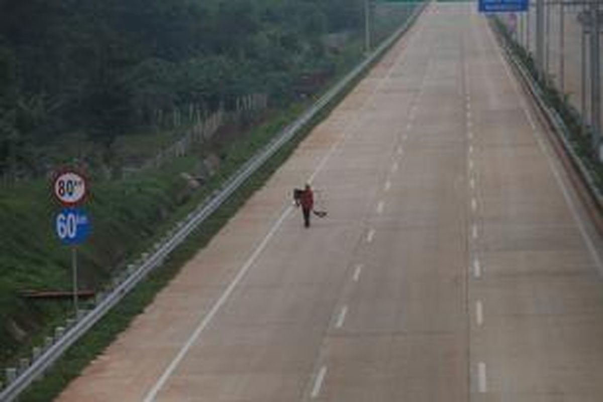 Warga melintasi ruas Tol Jakarta Outer Ring Road West 2 (JORR W2) Kebon Jeruk-Ciledug di kawasan Petukangan Utara, Jakarta Selatan, sebelum peresmian operasional jalan tol tersebut, Jumat (27/12/2013). Jalan tol sepanjang 5,8 kilometer itu merupakan bagian dari proyek JORR W2 yang akan menghubungkan ruas tol di TB Simatupang dan Tol Jakarta-Merak. 