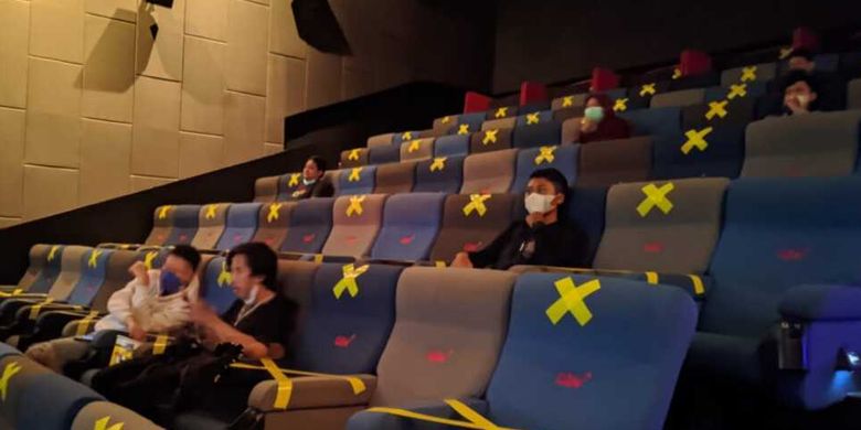 An Indonesian movie theater in Central Java follows the Covid-19 health protocols by using social distancing stickers. 