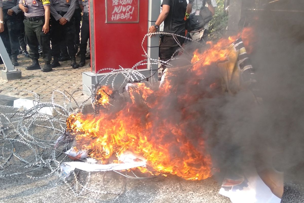 Massa aksi membakar kawat duri yang terpasang di depan gedung KPK, Senin (23/9/2019)