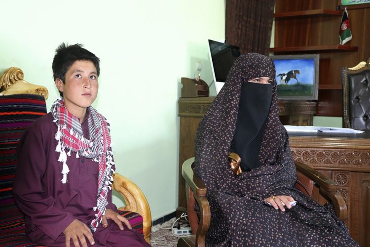 Qamar Gul (kanan), dan adiknya Habibullah (12) ketika berada di kantor gubernur di Feroz Koh, ibu kota Provinsi Ghor, barat Afghanistan, pada 21 Juli 2020. Remaja berusia 15 tahun dan adiknya dipuji setelah membunuh dua anggota Taliban karena orangtua mereka ditembak mati.