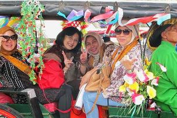 Para pencinta budaya yang tergabung dalam Wisata Budaya Warna-Warni Indonesia (WWI) naik Andong di Kota Solo, Jawa Tengah.