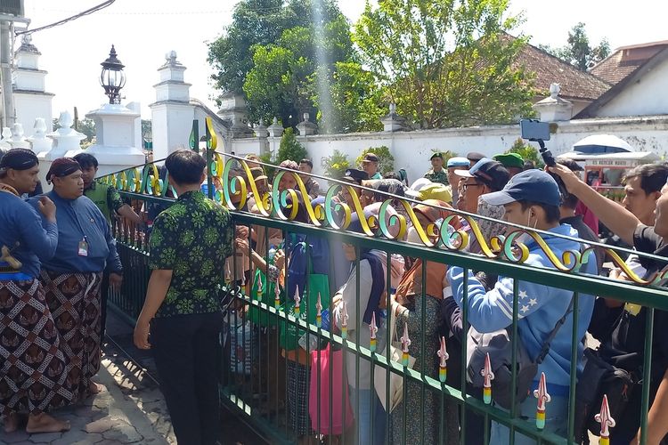 Warga mengantre untuk ambil air sisa jamasan dua keeta milik Keraton Yogyakarta, Jumat (28/7/2023)