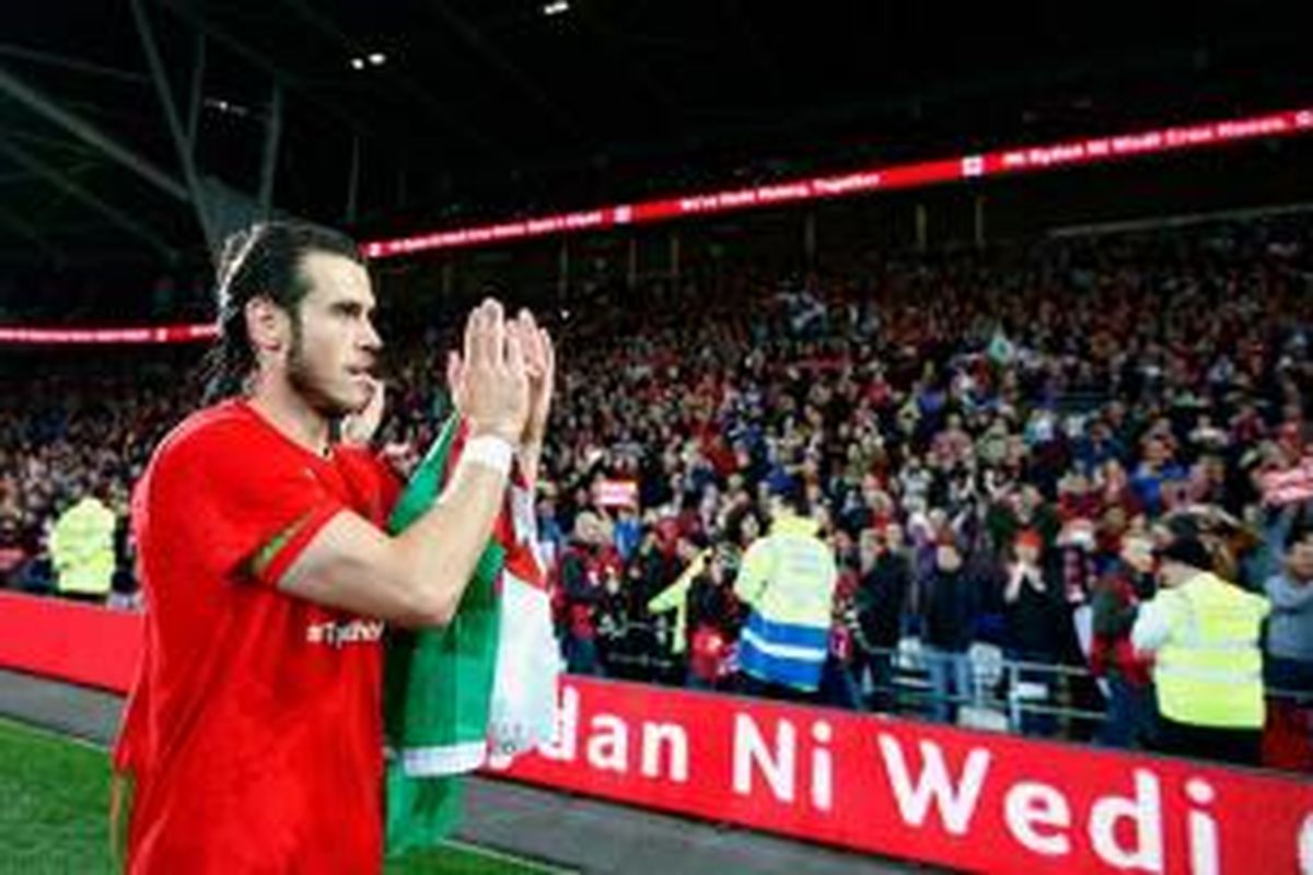 Gareth Bale memberi aplaus kepada penonton yang menjadi sumber kekuatan Wales lolos ke Piala Eropa 2016, Selasa (13/10/2015). 